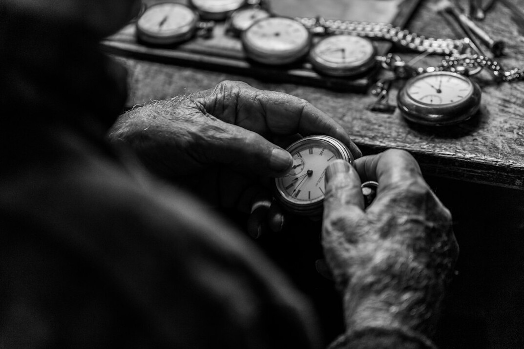 person inspecting vintage watch