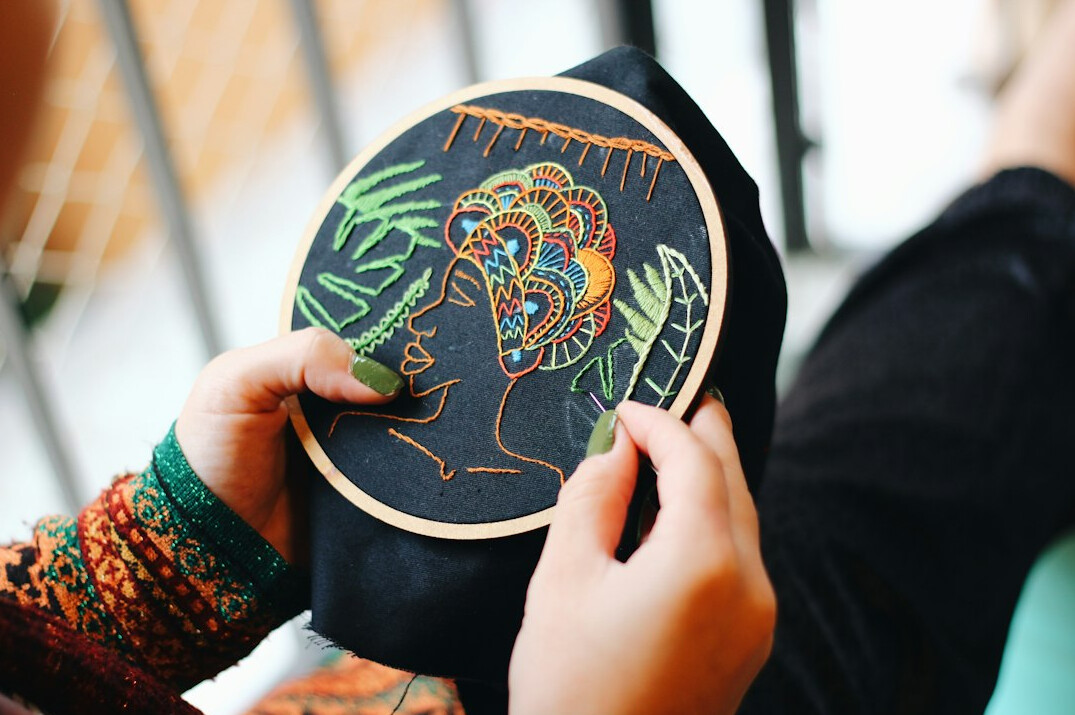 person stitching embroidery hoop